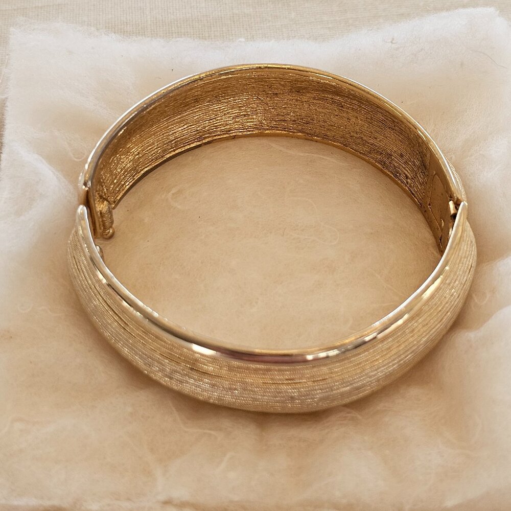 Vintage Monet, gold-toned metal bangle bracelet; ribbed, textured design